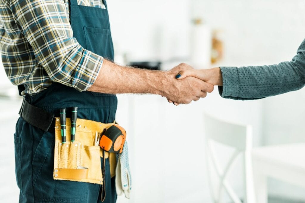 Two men shaking hands in a room.